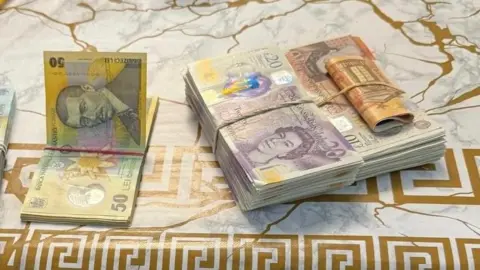 Armed police in Romania carry out raids linked to UK tax scam