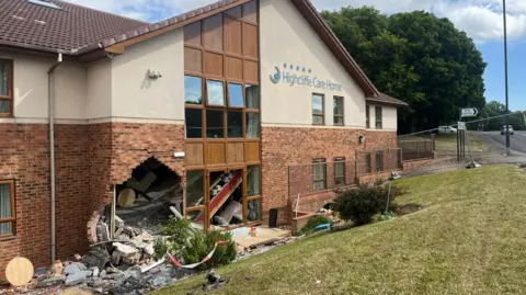 Two arrested as car crashes into care home